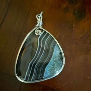 Pendant. I think it’s agate but I am not sure. Shades of grey and dark brown.